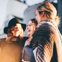 photo of three women talking and laughing